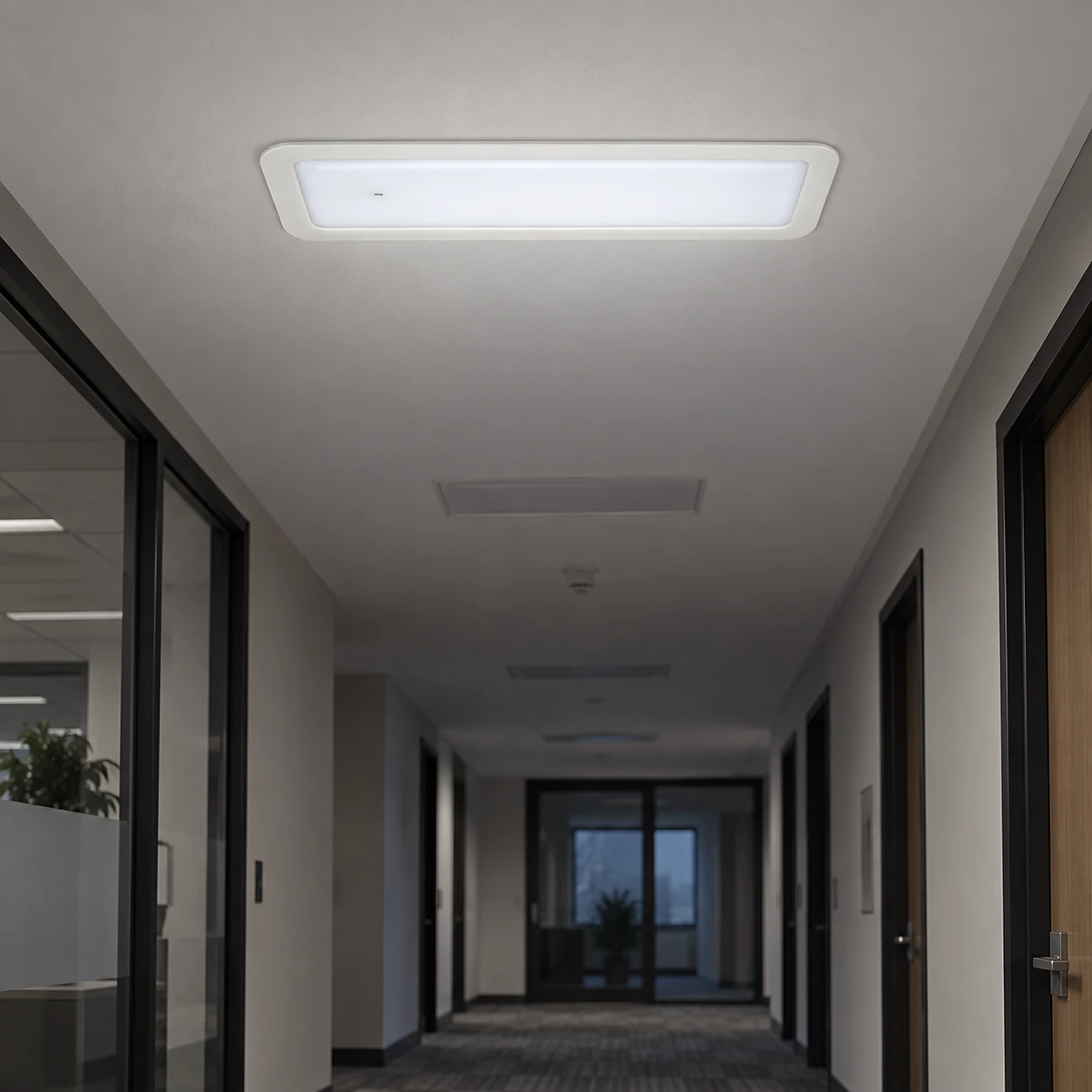 Illustrative BX-S034 emergency panel light recessed into a commercial corridor ceiling